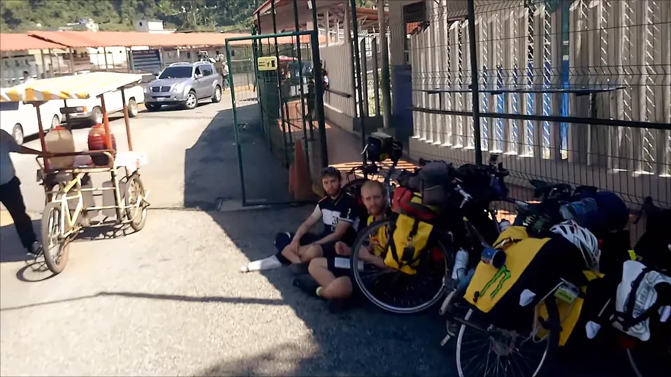 Loaded bikes leaning against the border building.