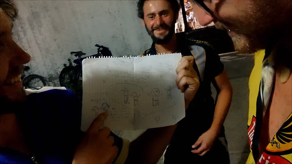 Riders laughing as they hold up a child’s drawing of the four of them.